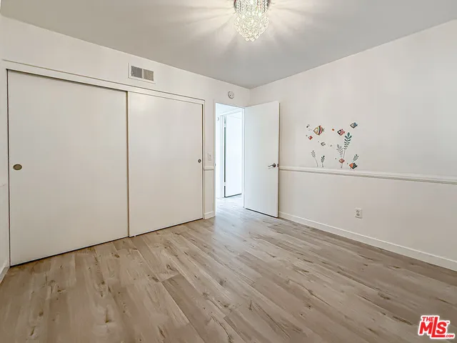 a view of a hardwood floor in a room