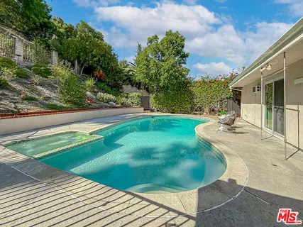 a view of a swimming pool with a yard