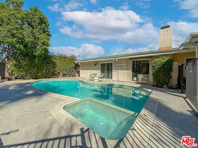 a view of house with swimming pool outdoor seating