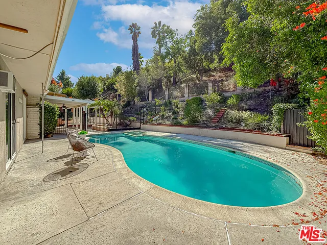 a view of a swimming pool with a patio