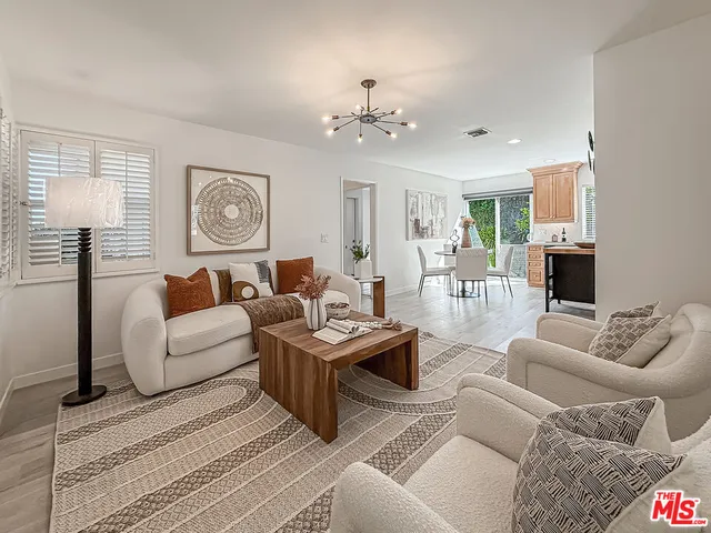 a living room with furniture a table and a window