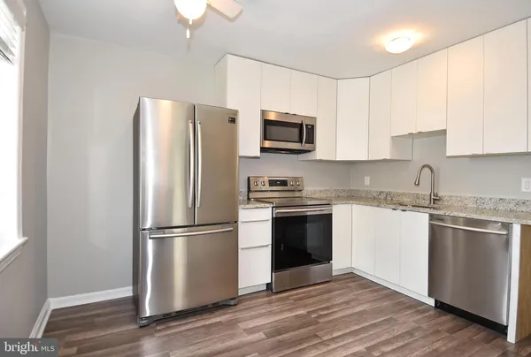 a kitchen with a refrigerator stove and sink