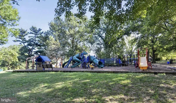 a view of a park with swings and slides