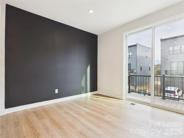 a view of a room with wooden floor