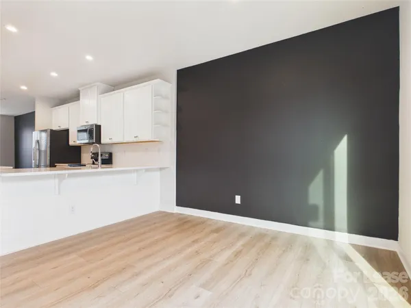 a view of a kitchen with wooden floor