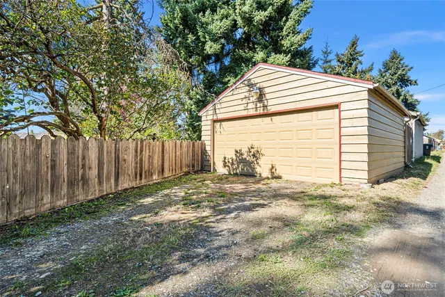 a view of backyard with wooden fence