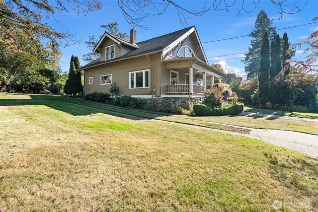 a view of house with yard outdoor space and swimming pool