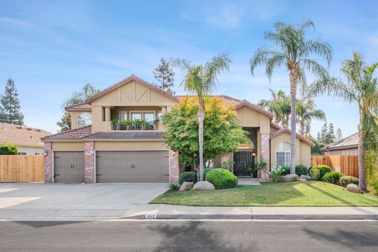 452 Omaha Avenue Clovis, CA 93619 - Photo 1 of 33 a front view of a house with a yard and garage