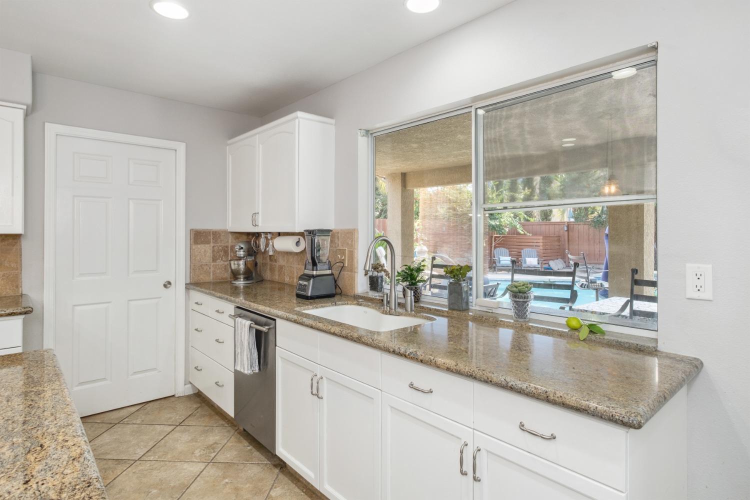 452 Omaha Avenue Clovis, CA 93619 - Photo 11 of 33 a kitchen with stainless steel appliances granite countertop a sink and a cabinets
