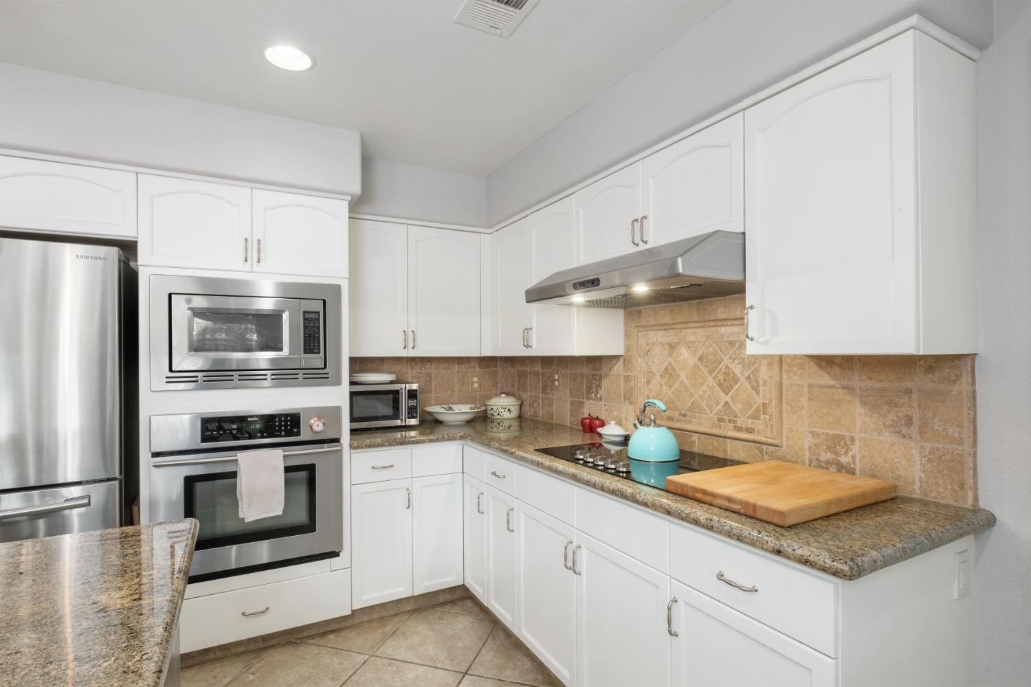 452 Omaha Avenue Clovis, CA 93619 - Photo 13 of 33 a kitchen with stainless steel appliances granite countertop a sink stove and refrigerator
