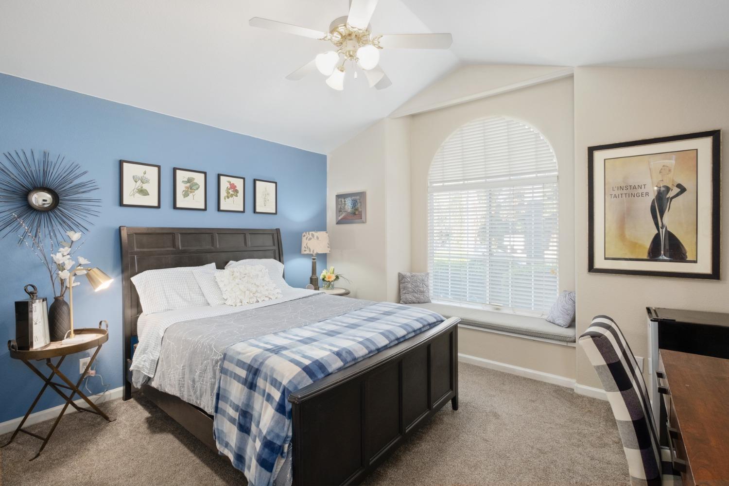 452 Omaha Avenue Clovis, CA 93619 - Photo 15 of 33 a bedroom with a bed and a chandelier