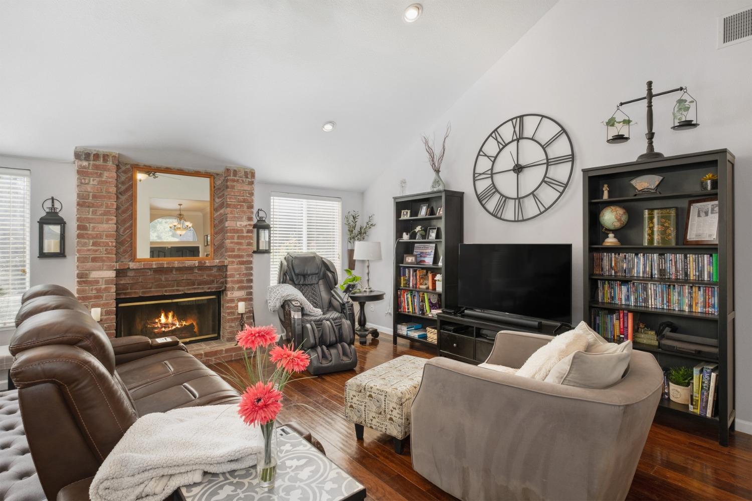 452 Omaha Avenue Clovis, CA 93619 - Photo 6 of 33 a living room with furniture a flat screen tv and a fireplace