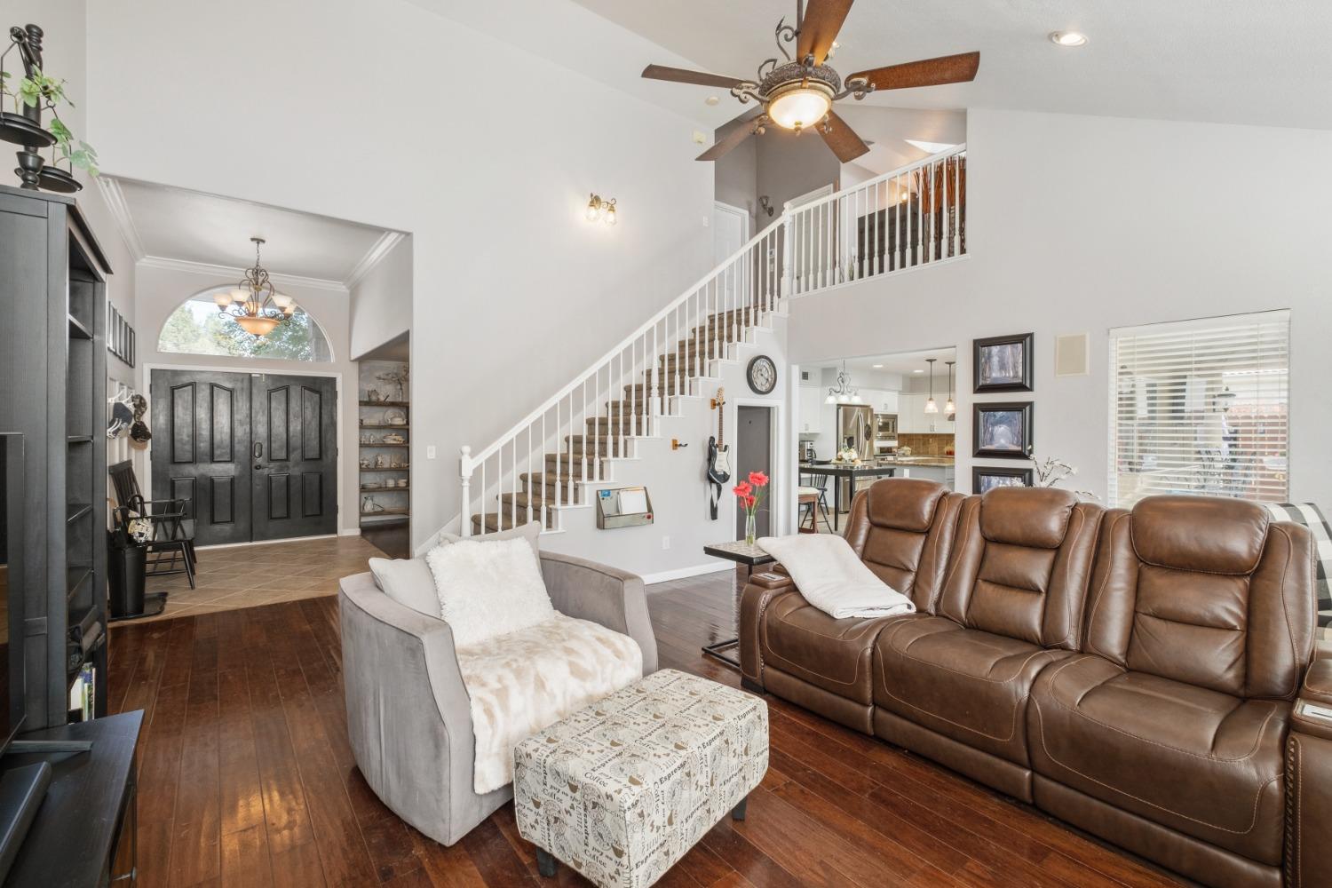 452 Omaha Avenue Clovis, CA 93619 - Photo 7 of 33 a living room with furniture a chandelier and wooden floor