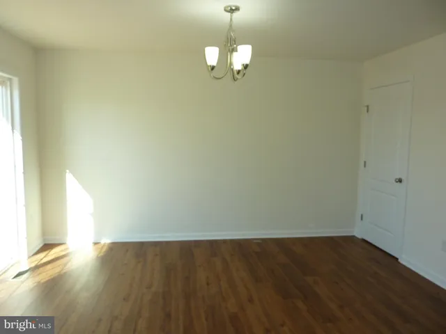 a view of a room with wooden floor and window