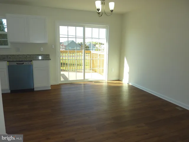 a view of wooden floor and windows in a room
