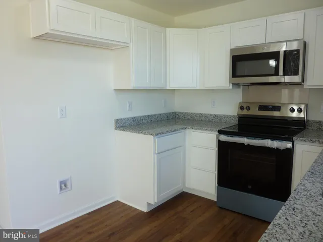 a kitchen with a stove and a microwave