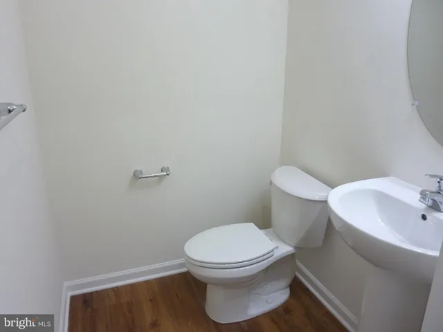 a white toilet sitting next to a bathroom sink