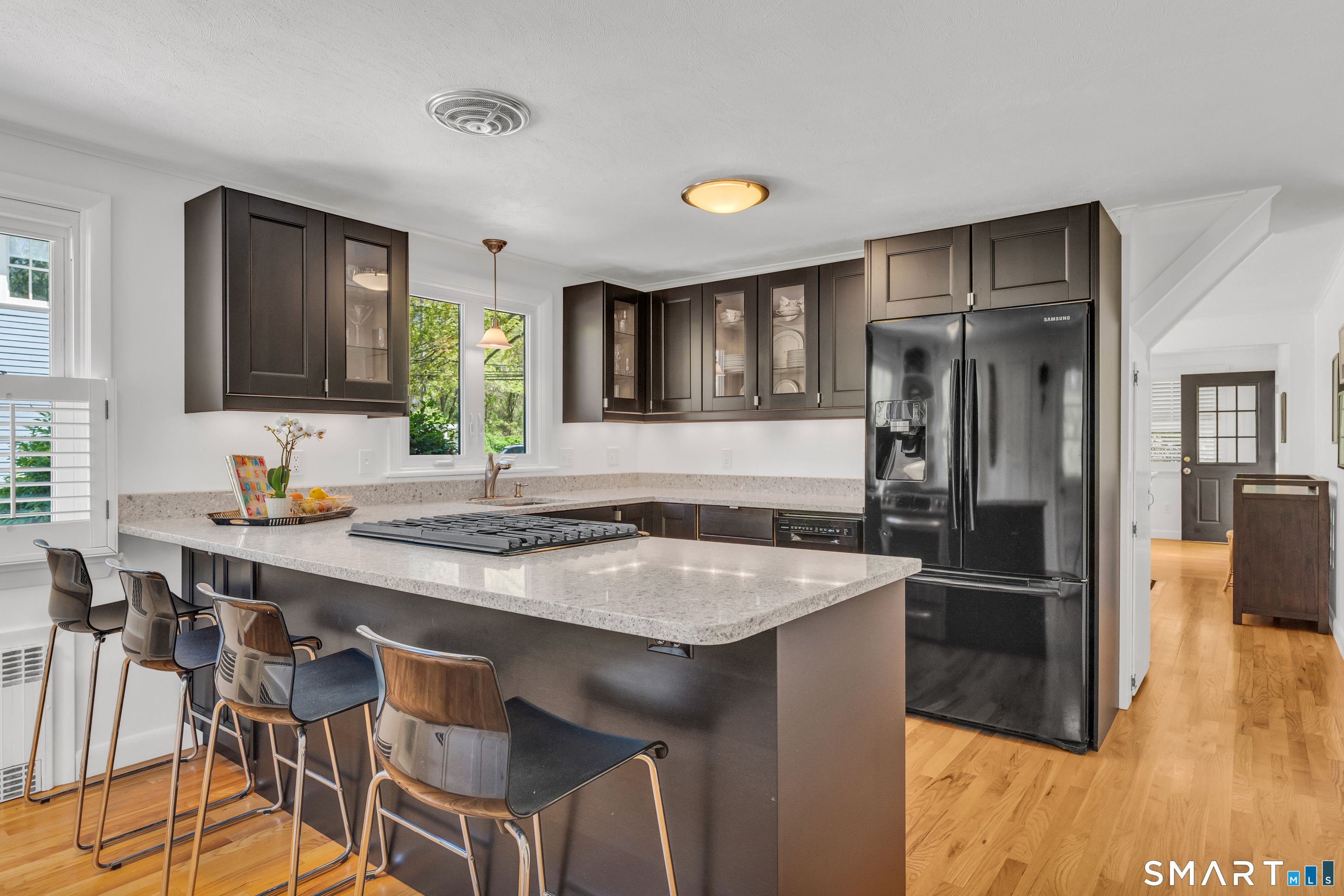 81 Main Street Chester, CT 06412 - Photo 13 of 39 Beautifully renovated kitchen with quartz counter tops, plenty of counter seating and lots of cabinet storage.