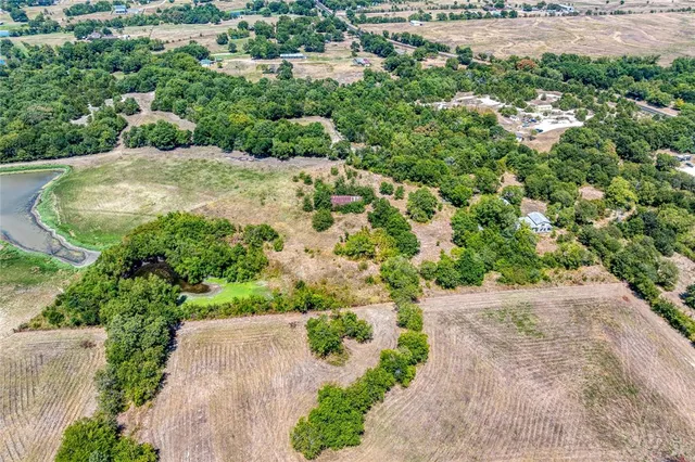 an aerial view of a houses with yard