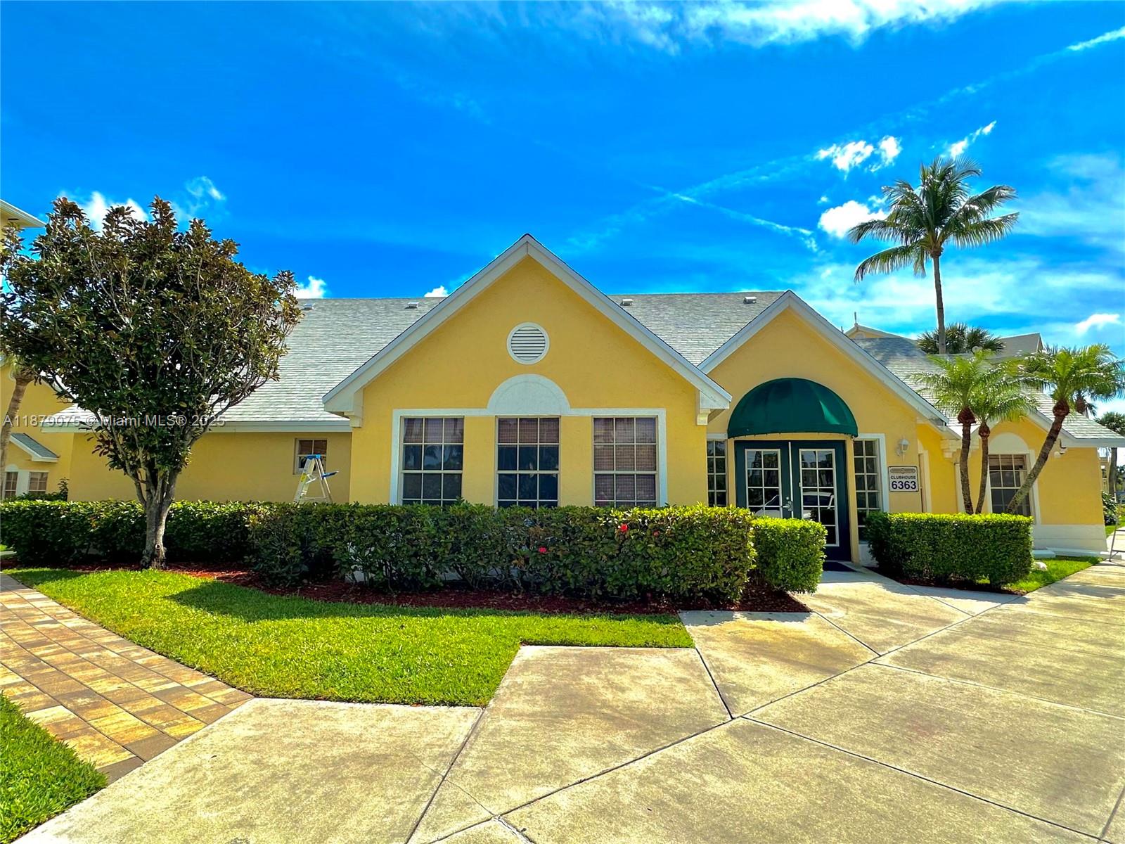 6340 La Costa Drive, Unit B Boca Raton, FL 33433 - Photo 14 of 16 a front view of a house with a yard
