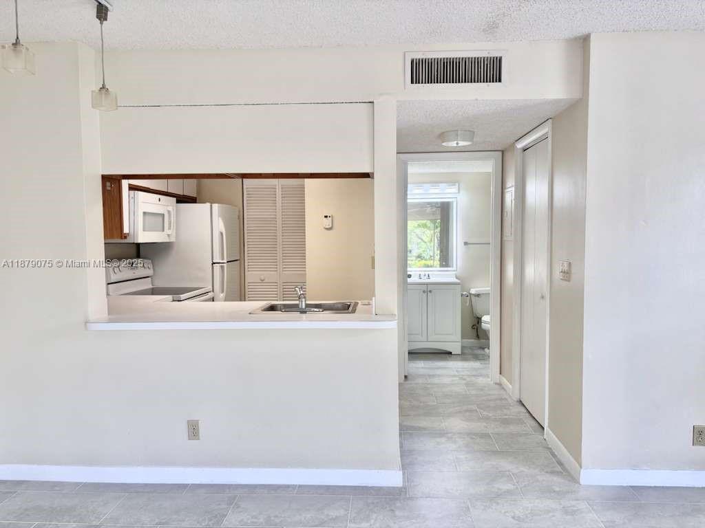 6340 La Costa Drive, Unit B Boca Raton, FL 33433 - Photo 2 of 16 a view of kitchen with cabinets