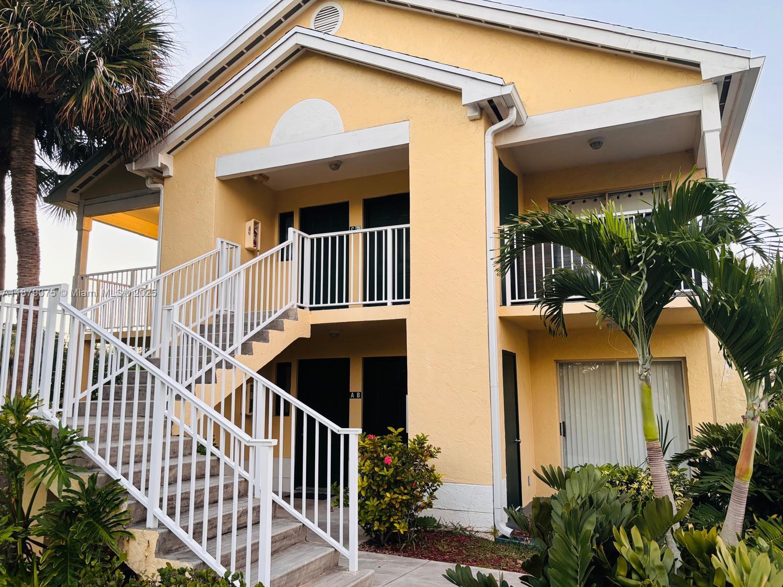 6340 La Costa Drive, Unit B Boca Raton, FL 33433 - Photo 10 of 16 a view of a house with a small yard and plants