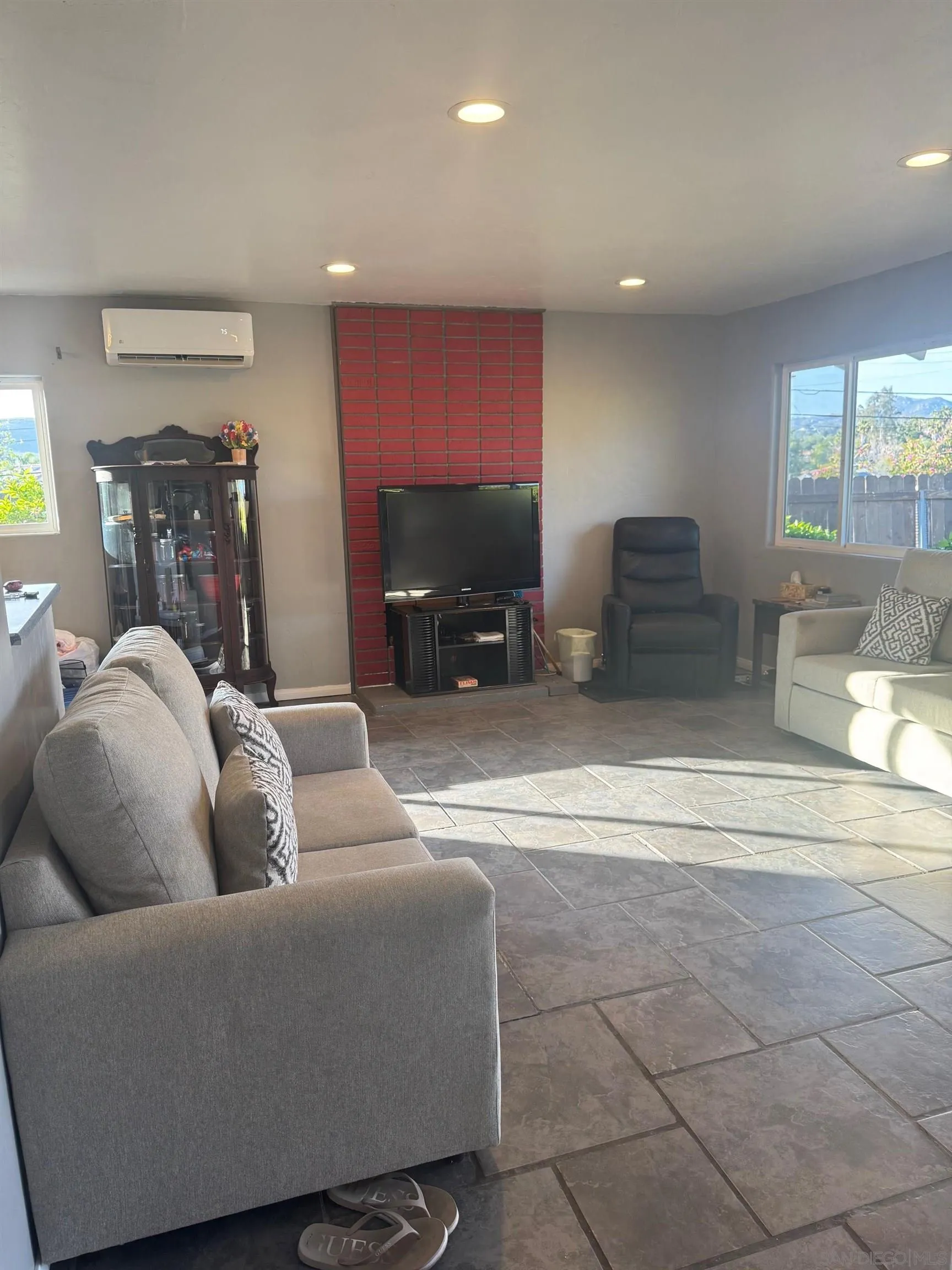 12710 Montauk Street Poway, CA 92064 - Photo 40 of 51 a living room with furniture a flat screen tv and a large window