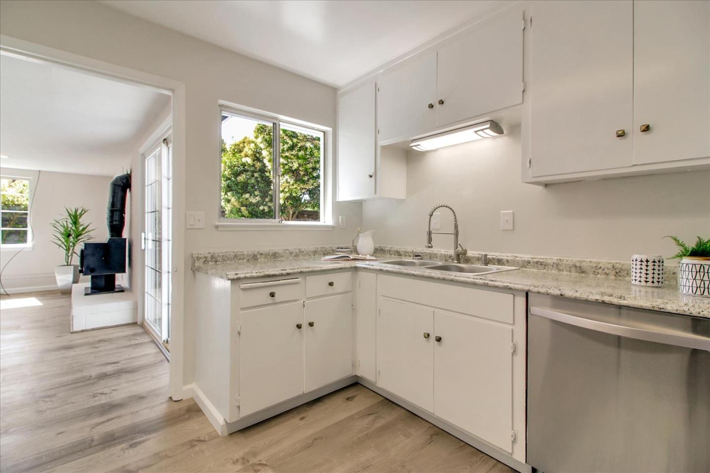 1693 Beck Drive San Jose, CA 95130 - Photo 16 of 37 a kitchen with granite countertop white cabinets white appliances and a wide window