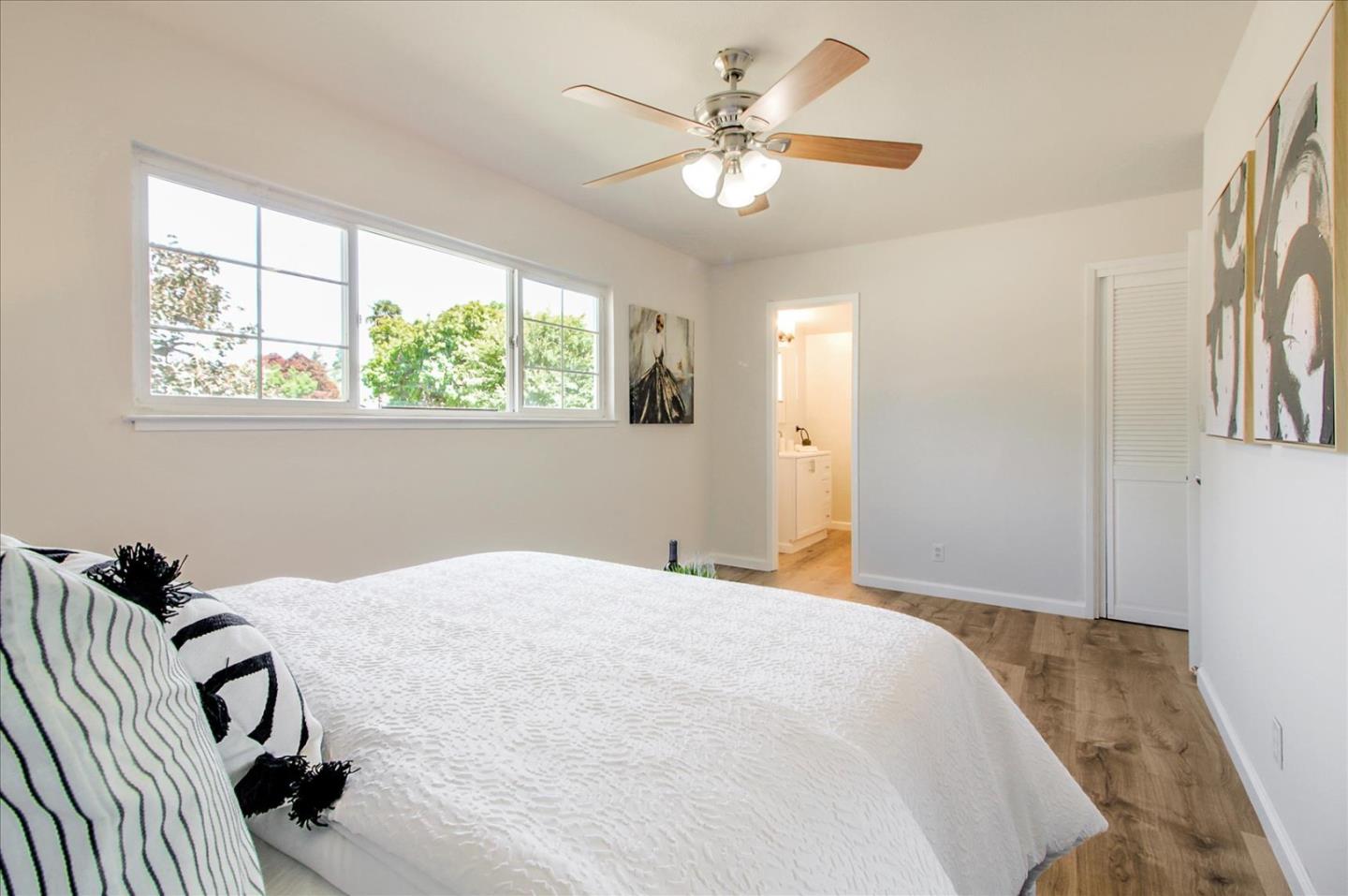 1693 Beck Drive San Jose, CA 95130 - Photo 21 of 37 a bedroom with a bed and a chandelier