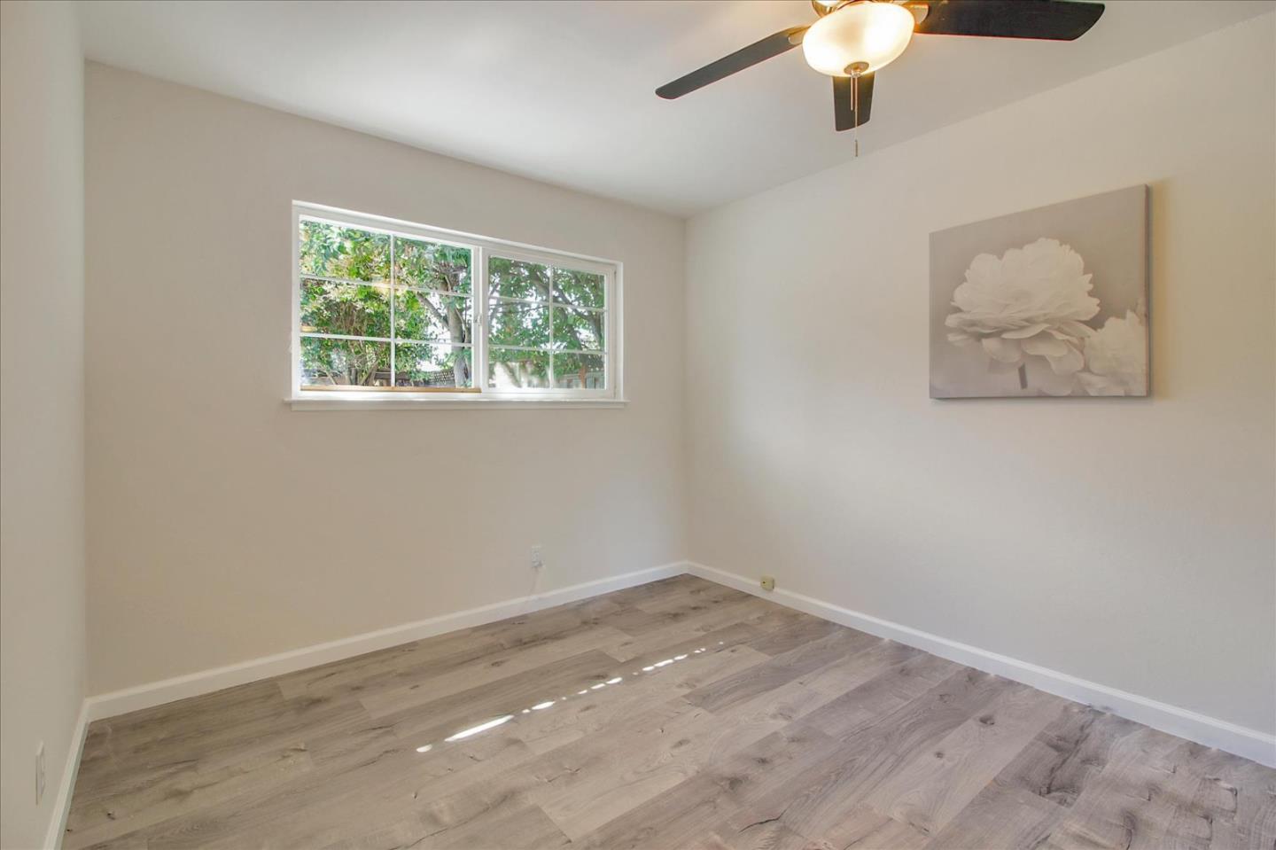 1693 Beck Drive San Jose, CA 95130 - Photo 26 of 37 an empty room with a window and a ceiling fan