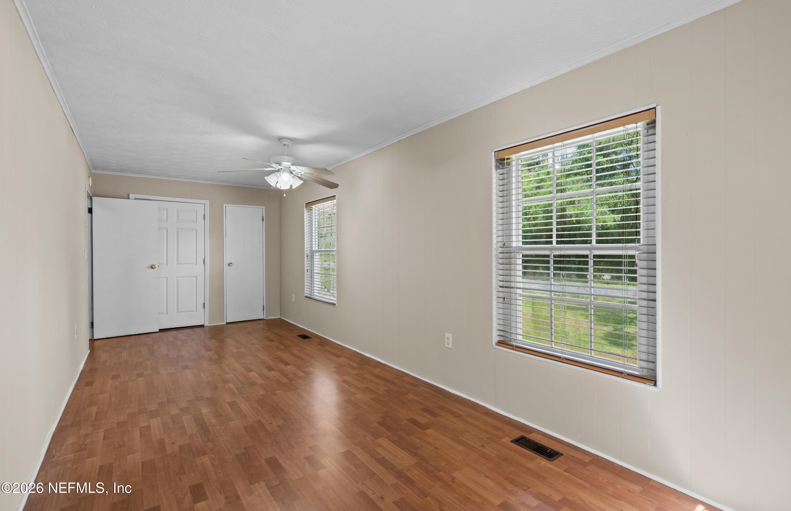 253 Cowry Road St. Augustine, FL 32086 - Photo 13 of 27 a view of an empty room with wooden floor and a window