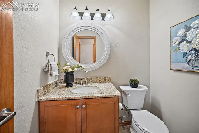 a bathroom with a toilet a sink and a mirror