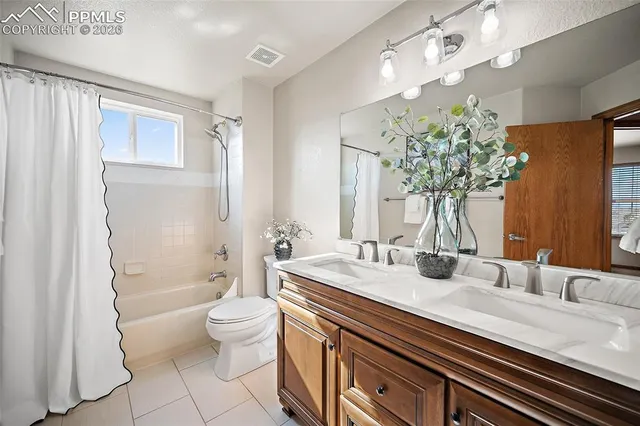 a bathroom with a granite countertop sink a toilet and a mirror