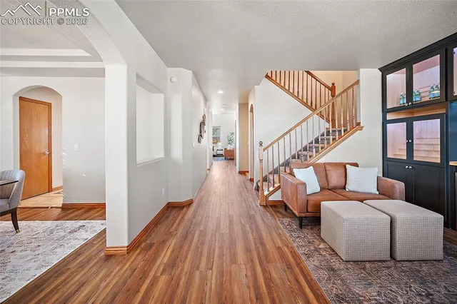 a living room with furniture and a wooden floor