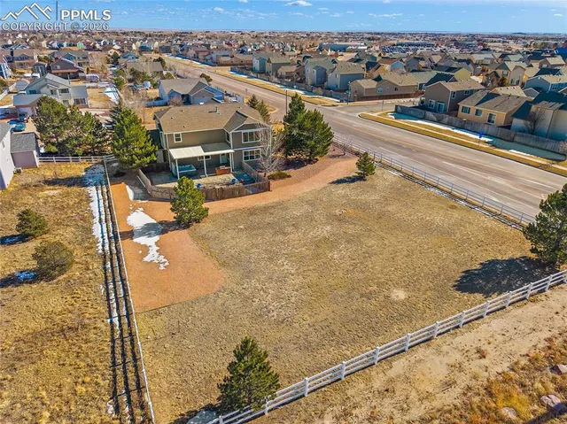 an aerial view of residential houses with outdoor space
