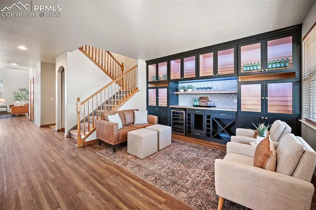 a living room with furniture and a wooden floor