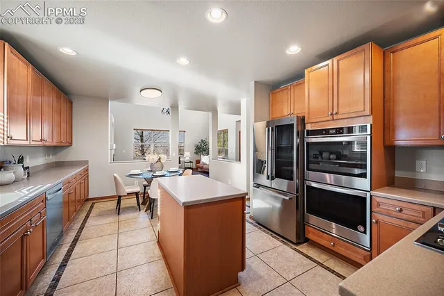 a kitchen with counter top space cabinets and stainless steel appliances