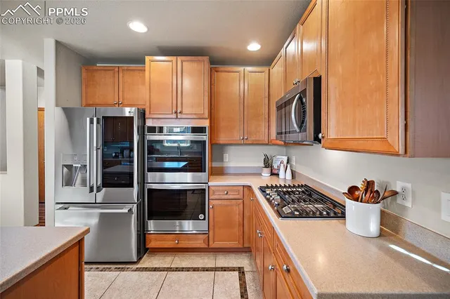 a kitchen with stainless steel appliances a refrigerator sink and cabinets