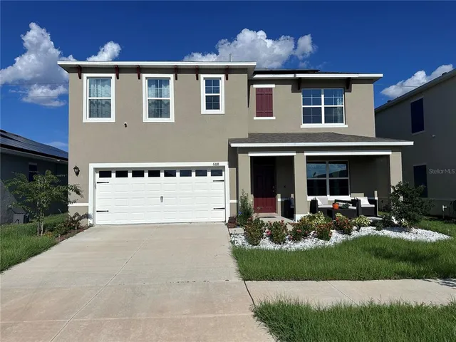 a front view of a house with sitting space and garden