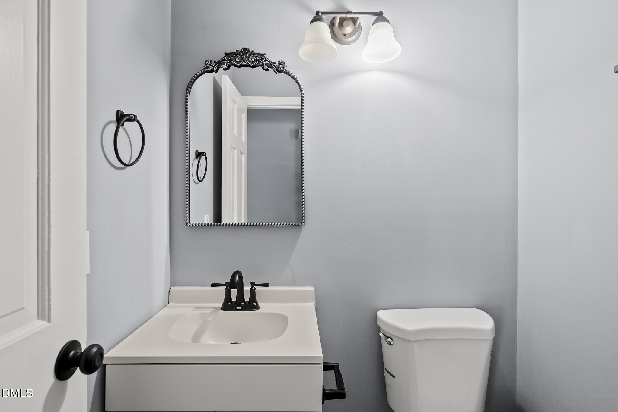 2108 Treverton Place Raleigh, NC 27609 - Photo 18 of 30 a bathroom with a toilet sink and mirror