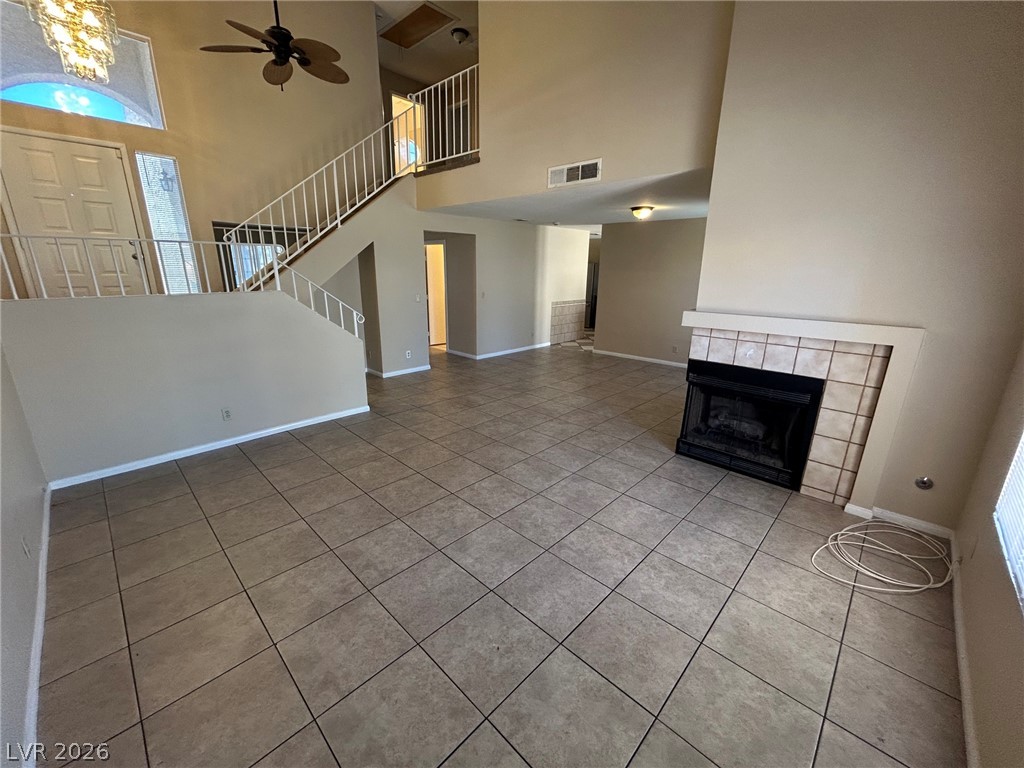2806 Rungsted Street Las Vegas, NV 89142 - Photo 2 of 18 A spacious common area boasts soaring ceilings, tile flooring, and a cozy fireplace, perfect for gathering.