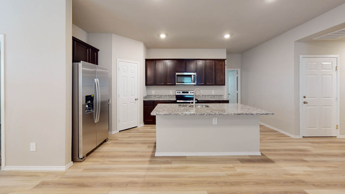 561 Hector Loop Georgetown, TX 78626 - Photo 8 of 30 a view of kitchen with stainless steel appliances granite countertop a refrigerator and a stove top oven
