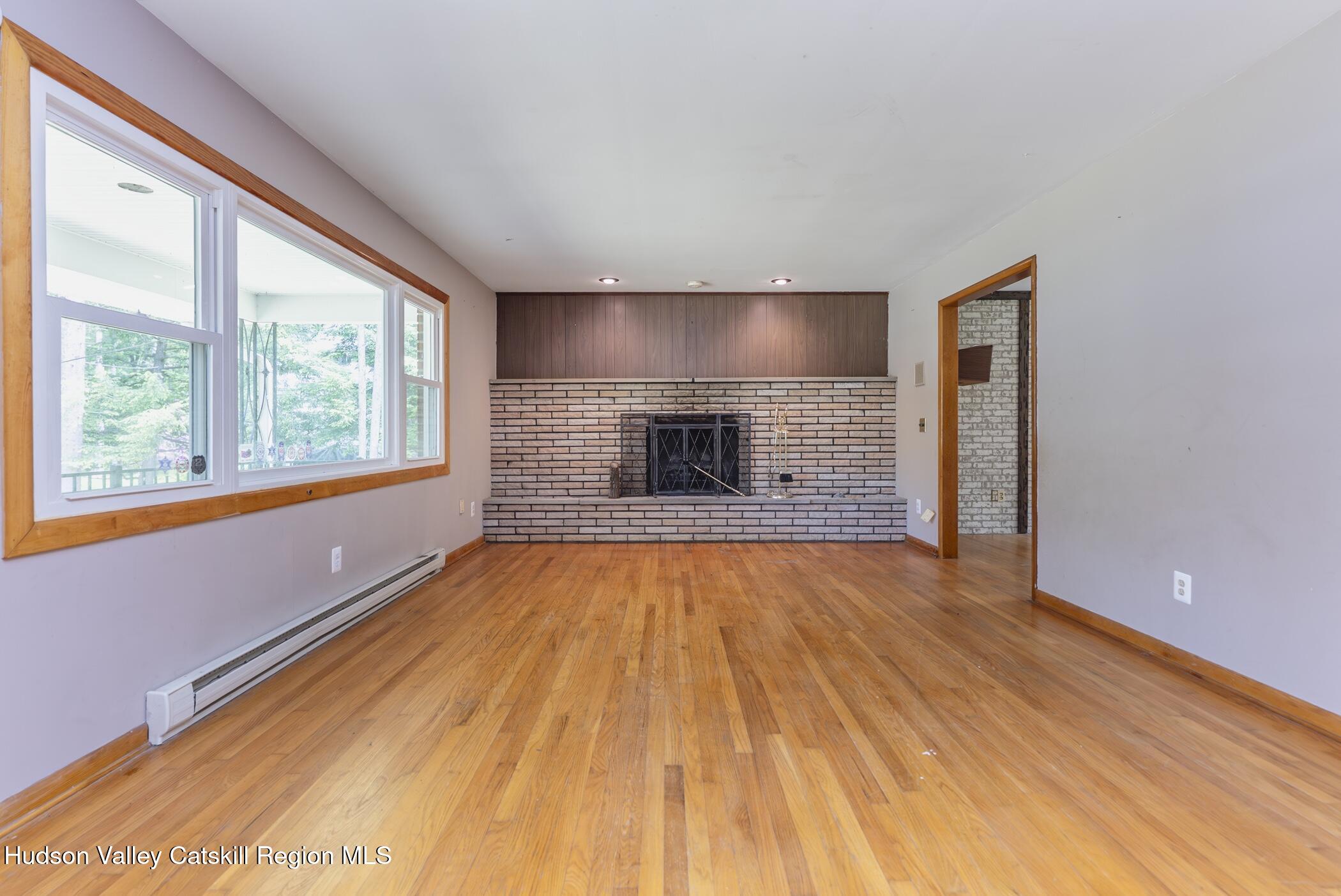 22 Robert Drive Hyde Park, NY 12538 - Photo 14 of 52 a view of empty room with wooden floor and fireplace
