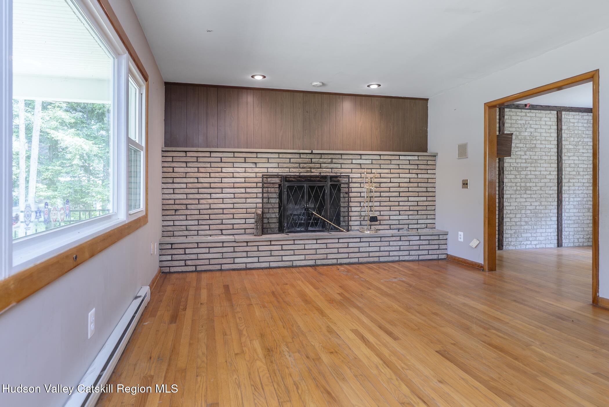 22 Robert Drive Hyde Park, NY 12538 - Photo 15 of 52 a view of a livingroom with wooden floor and a fireplace