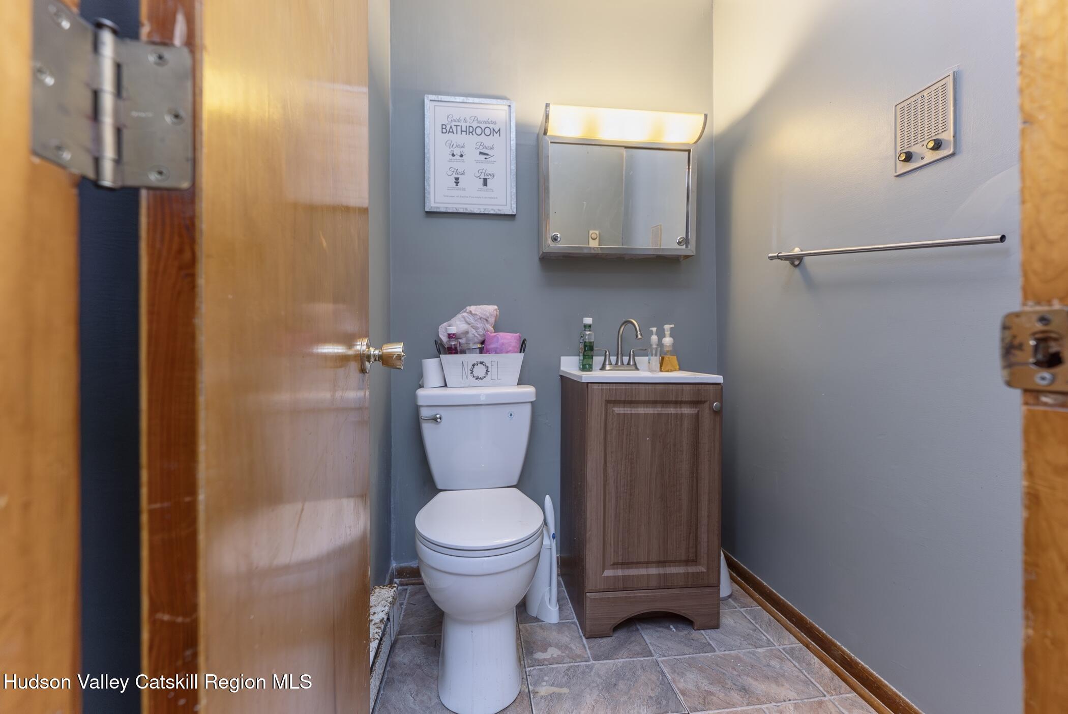 22 Robert Drive Hyde Park, NY 12538 - Photo 26 of 52 a white toilet sitting next to a bathroom sink