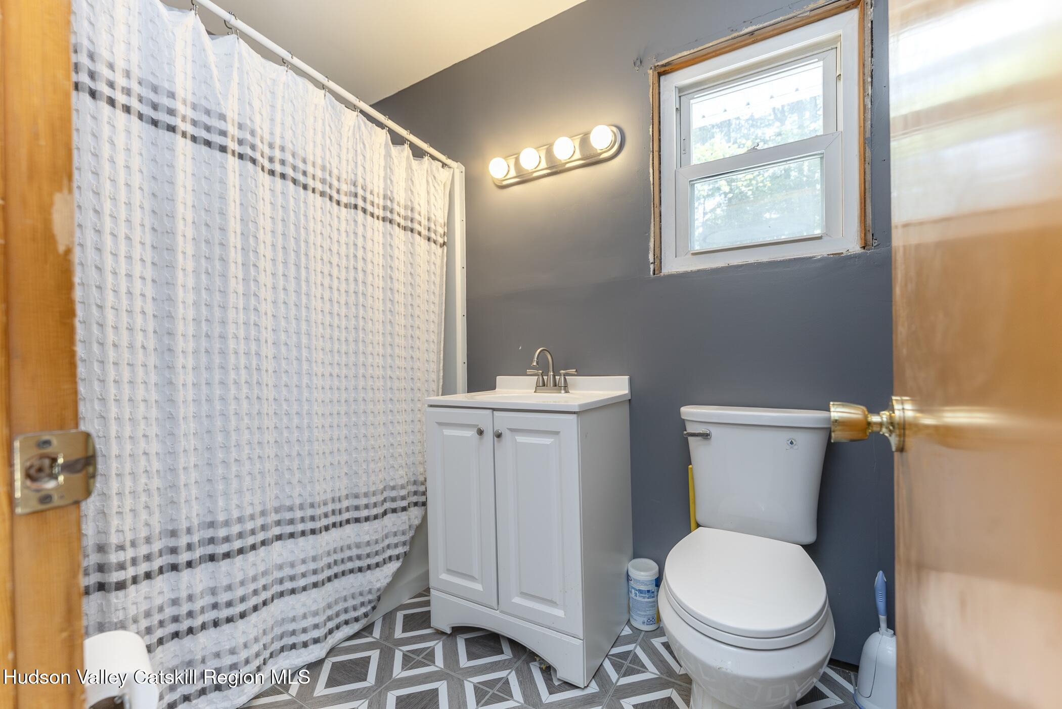 22 Robert Drive Hyde Park, NY 12538 - Photo 30 of 52 a bathroom with a toilet a sink and a shower