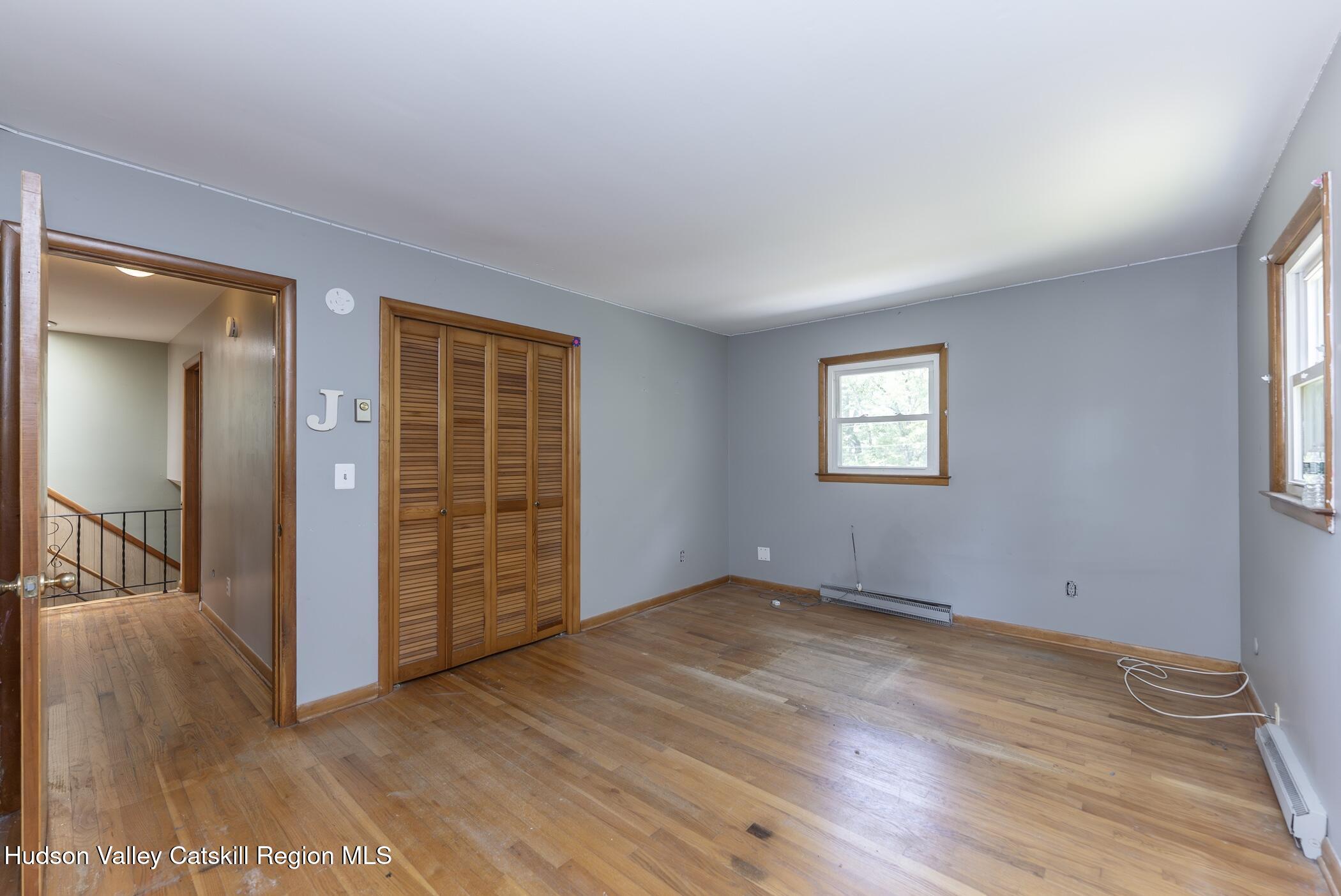 22 Robert Drive Hyde Park, NY 12538 - Photo 36 of 52 an empty room with wooden floor cabinet and windows