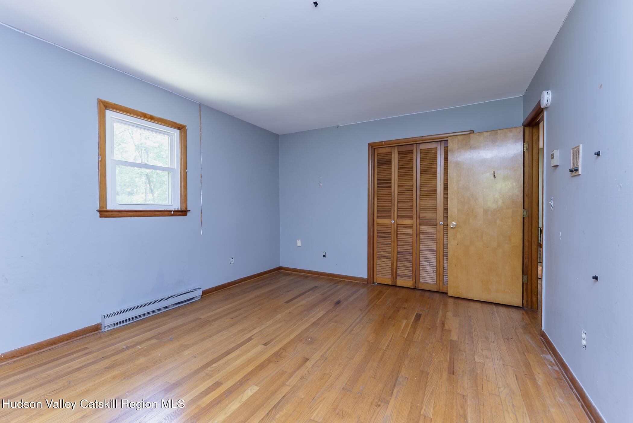 22 Robert Drive Hyde Park, NY 12538 - Photo 38 of 52 a view of an empty room with wooden floor and a window