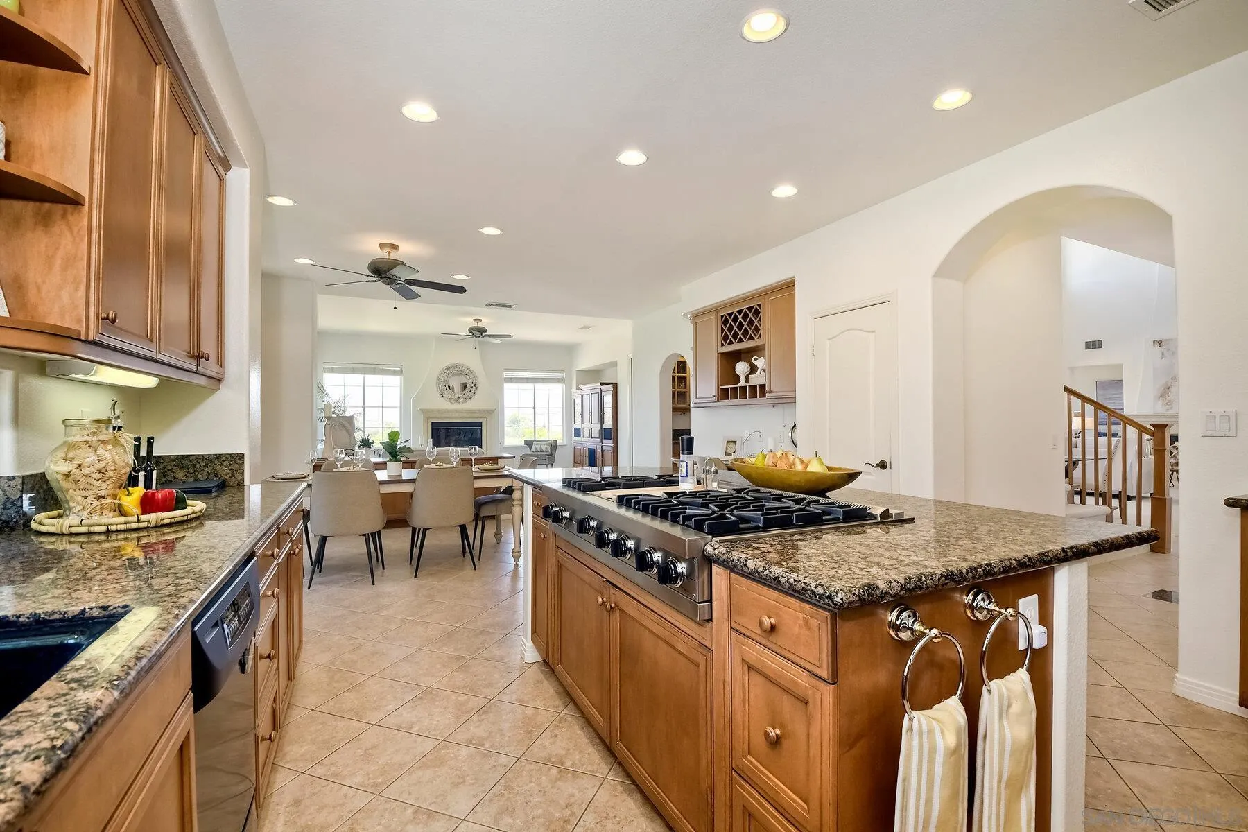 13660 Overland Pass Road Poway, CA 92064 - Photo 18 of 61 a kitchen with stainless steel appliances granite countertop a stove a sink a oven and a dining table