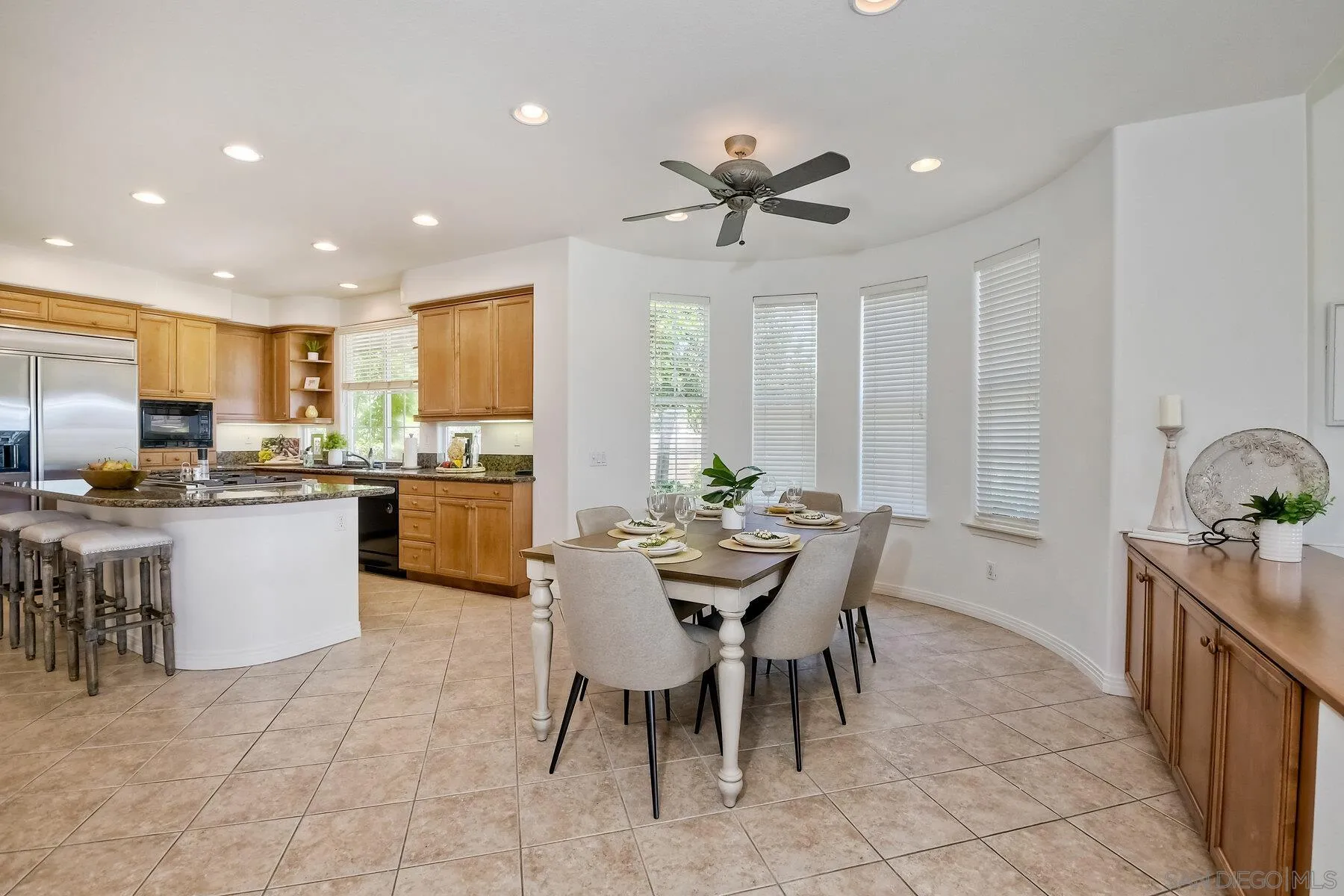 13660 Overland Pass Road Poway, CA 92064 - Photo 21 of 61 a kitchen with kitchen island granite countertop wooden cabinets and stainless steel appliances